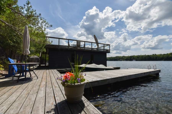 Waterfront with patio table, chair, umbrella, and lounge chairs